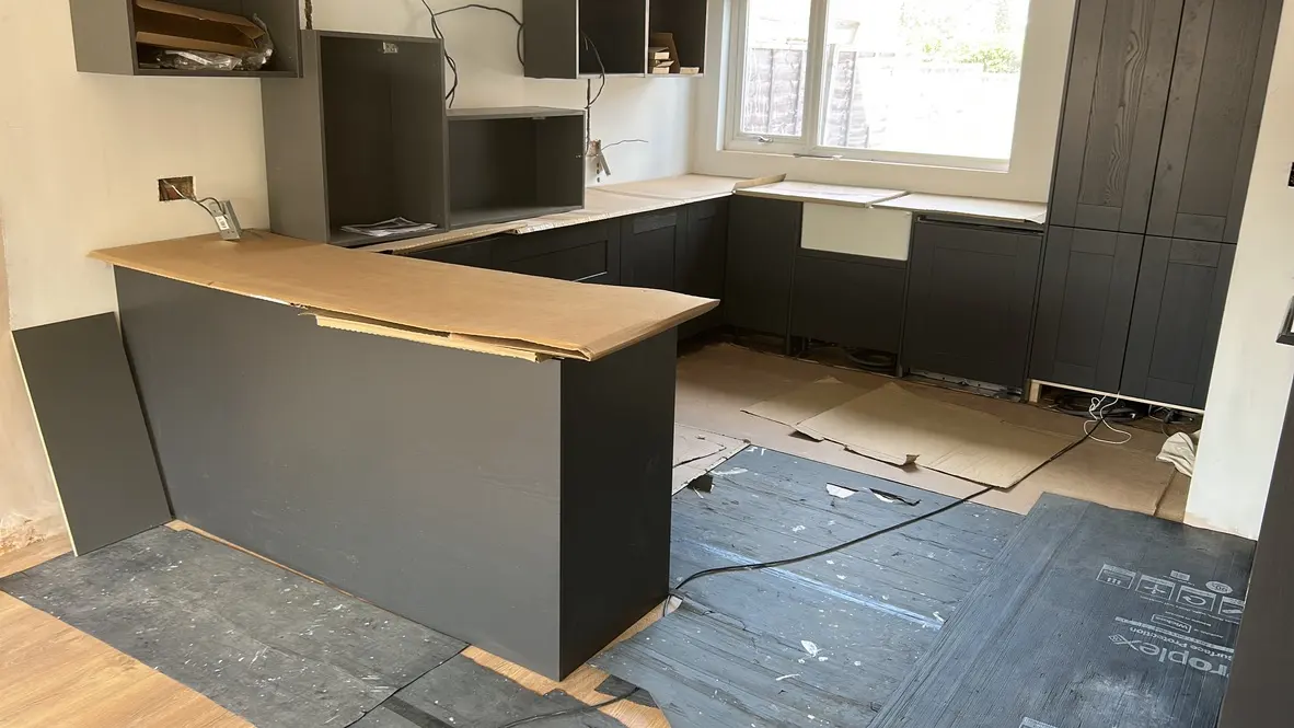 Charcoal shaker base units and peninsula fitted, wall units being hung