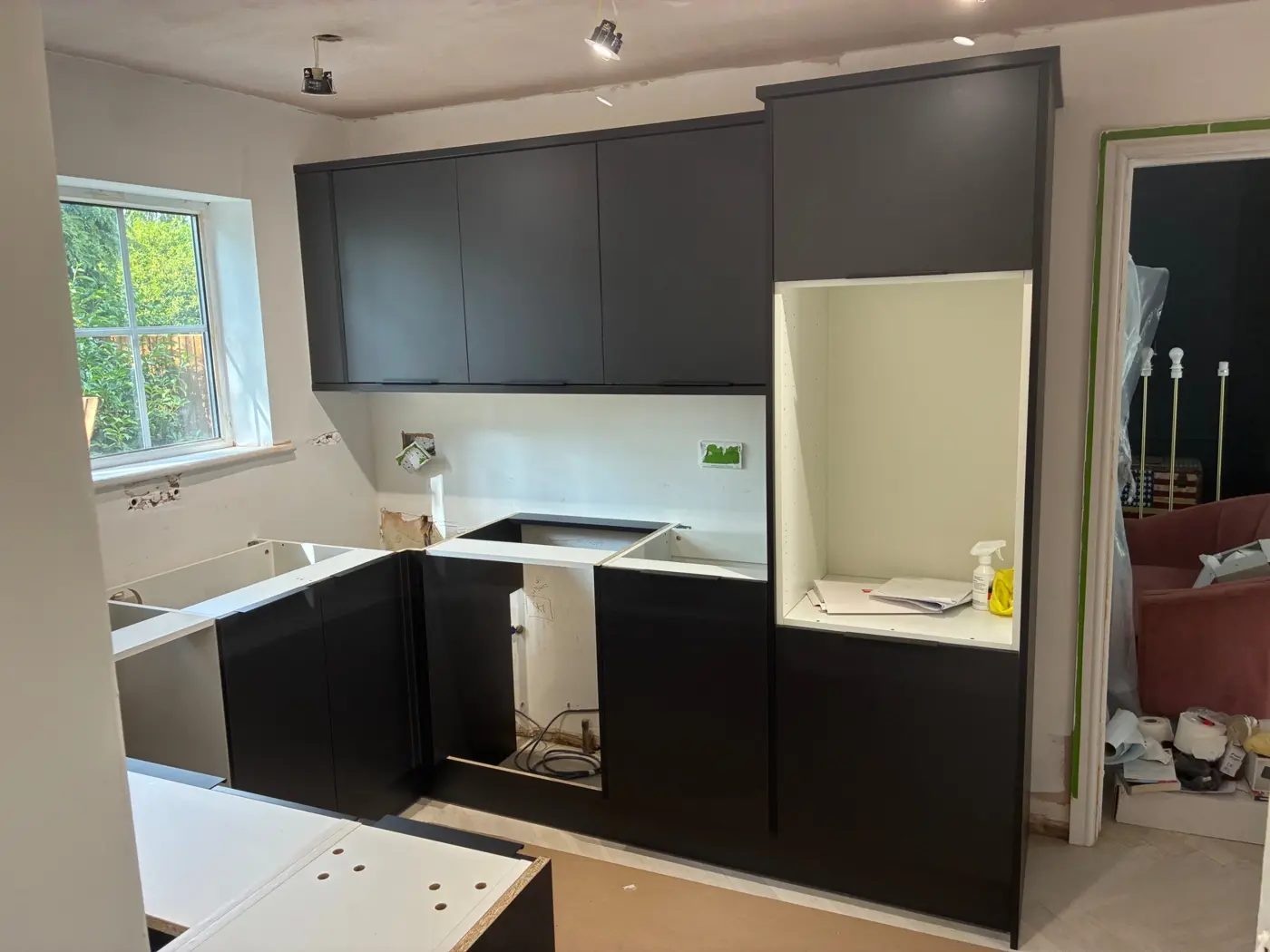 Matt charcoal handleless units fitted, worktops not yet on