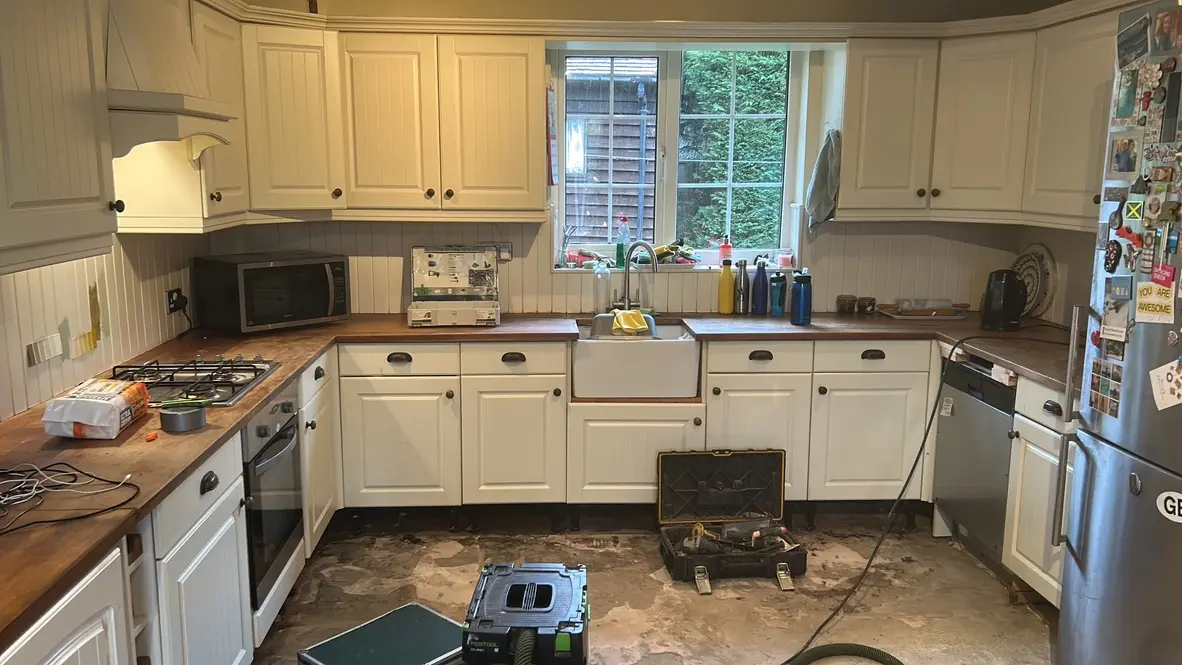 Old cream tongue-and-groove kitchen with wooden worktops before removal