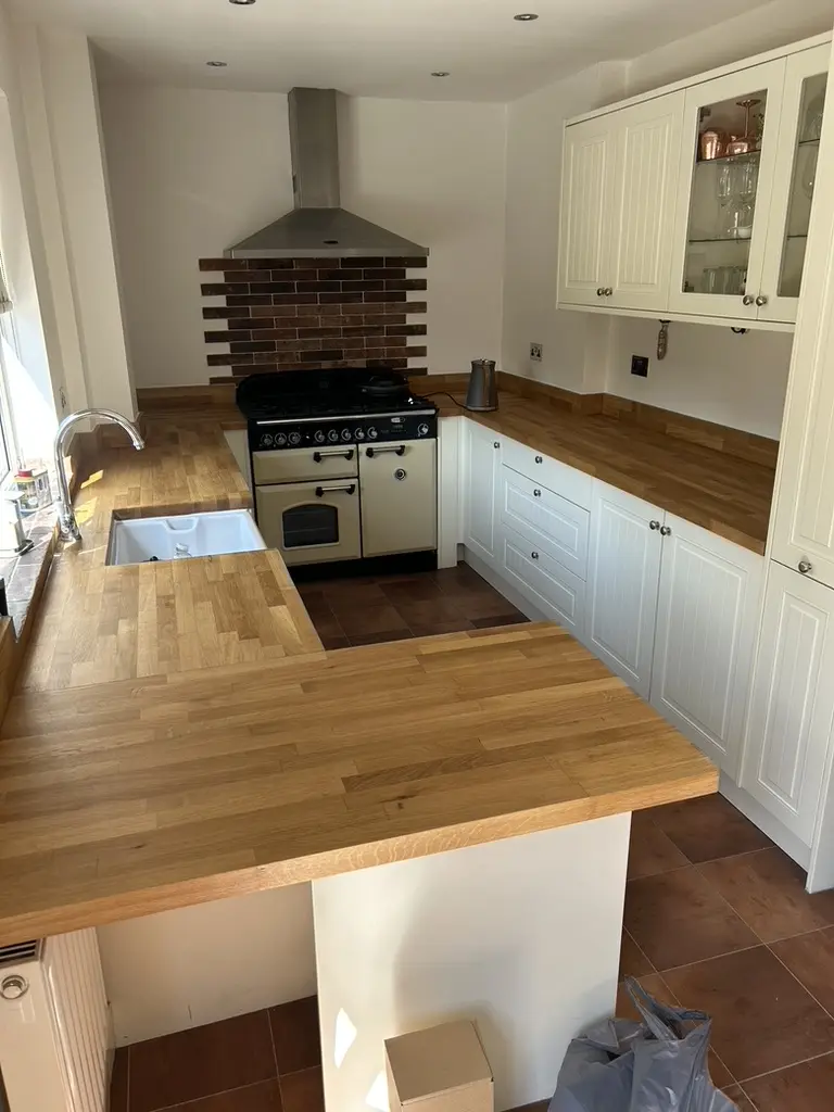 Cream tongue-and-groove kitchen with solid oak worktops, belfast sink and range cooker
