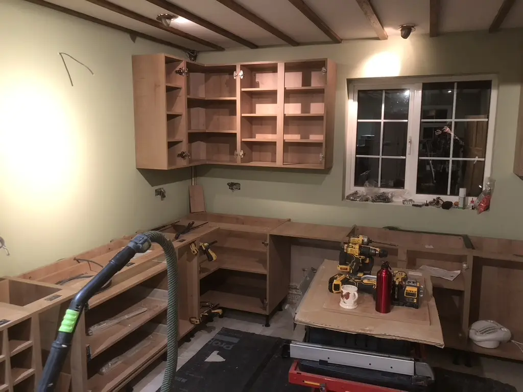 Base and wall cabinet carcasses fitted with tools on site