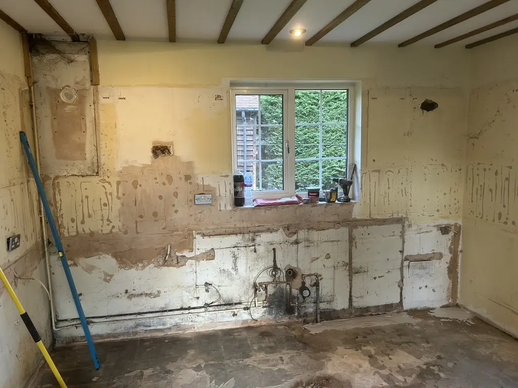 Room stripped back to bare walls and pipework