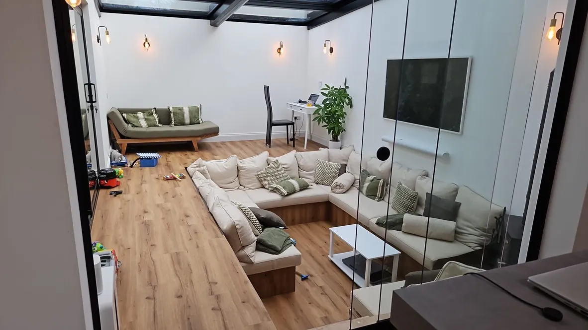 View into the sunken lounge from the kitchen through the glass screen