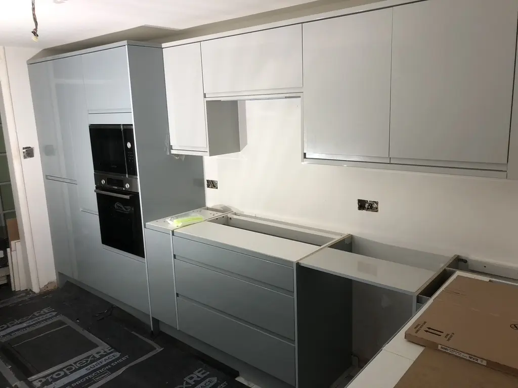 Grey gloss tall housing with built-in oven and microwave, drawer run and wall units