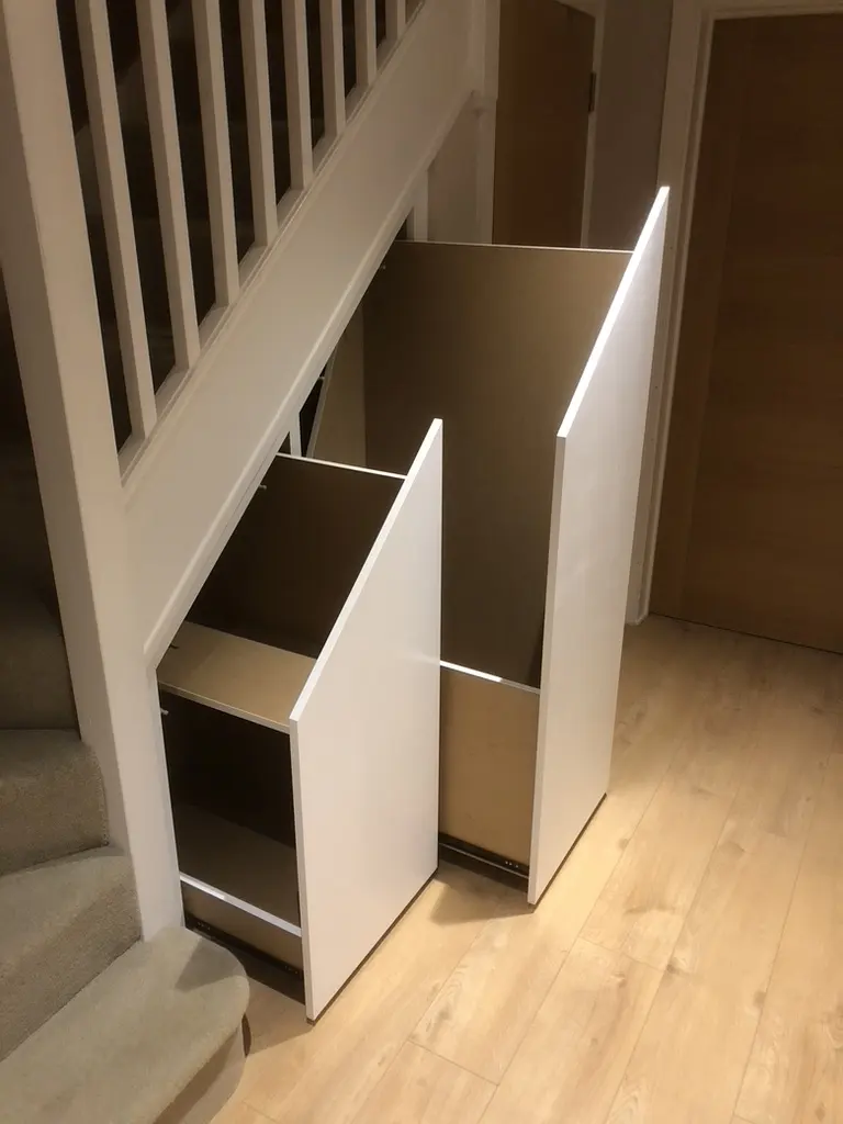 Two tall pull-out units drawn out from under the stairs
